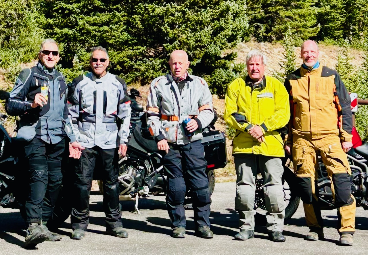 Five riders in gear Colorado mountain stop 2026