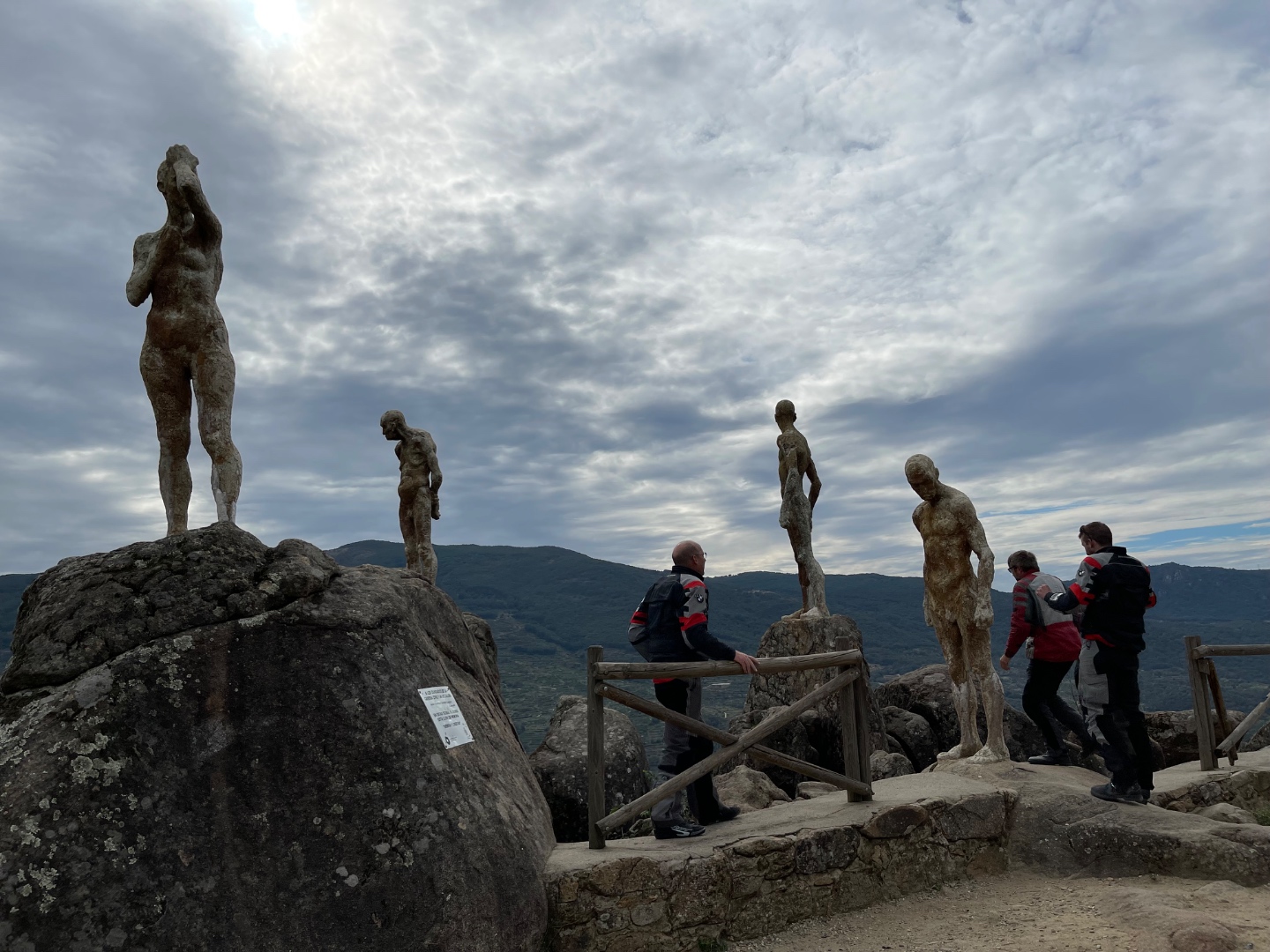 Bronze figure sculptures on granite boulders, riders exploring outdoor sculpture park, Ávila Province